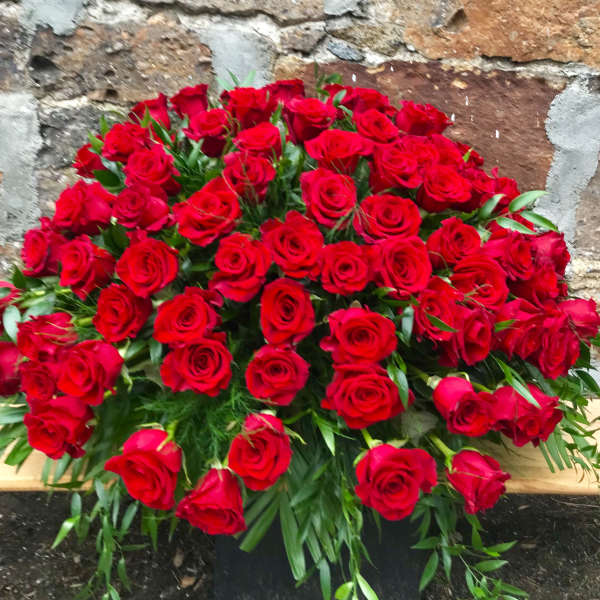 Large bouquet of red roses with greenery