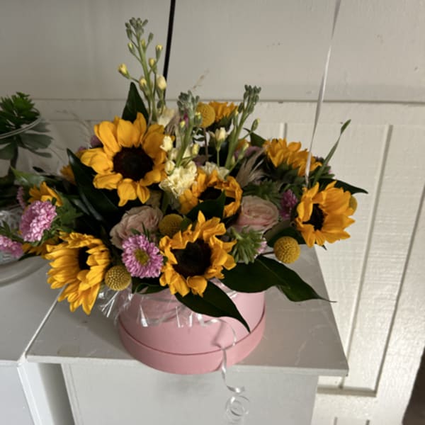 Pink box of sunflowers and small pink flowers
