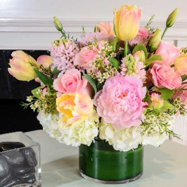 Pink and peach tulips with roses in a green vase