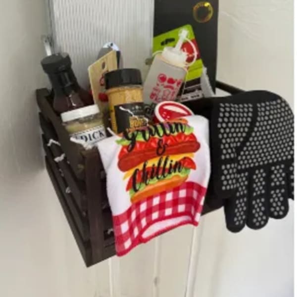 Gift basket with condiments, a towel, and kitchen items