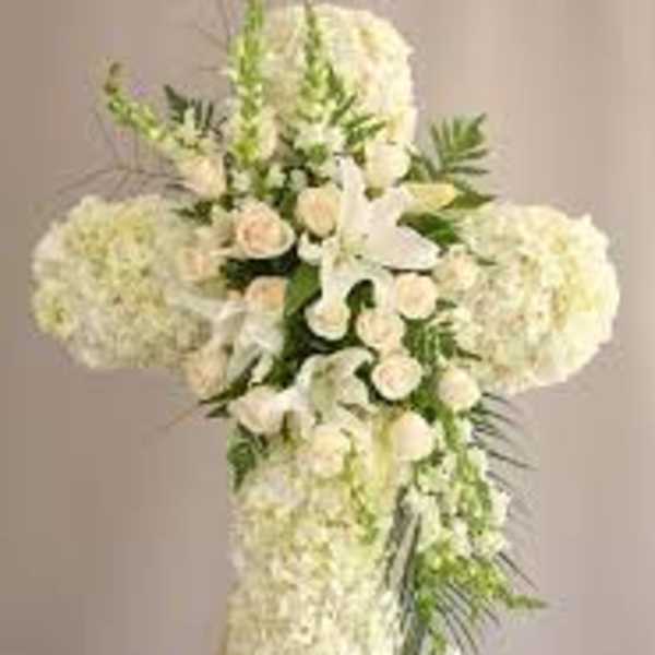 White floral cross arrangement with cascading blooms