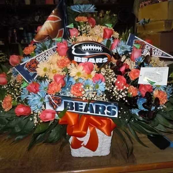 Large floral arrangement with Chicago Bears decorations and a football centerpiece