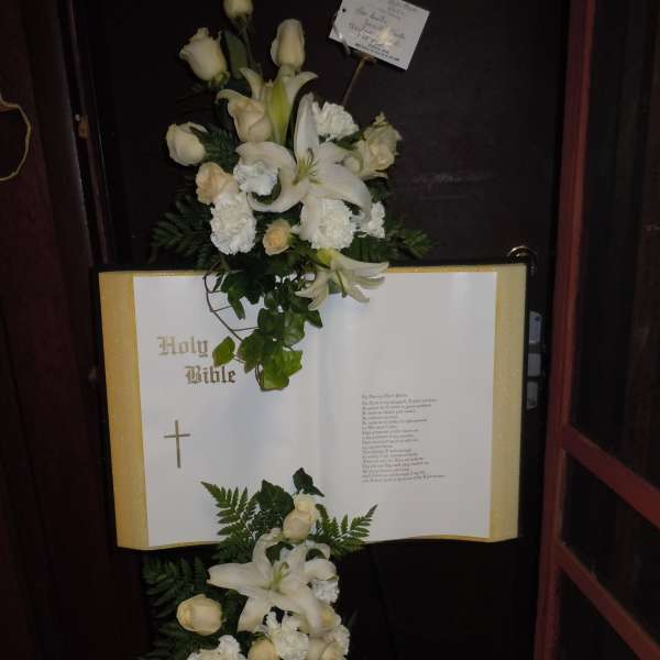White floral spray on an open Bible display