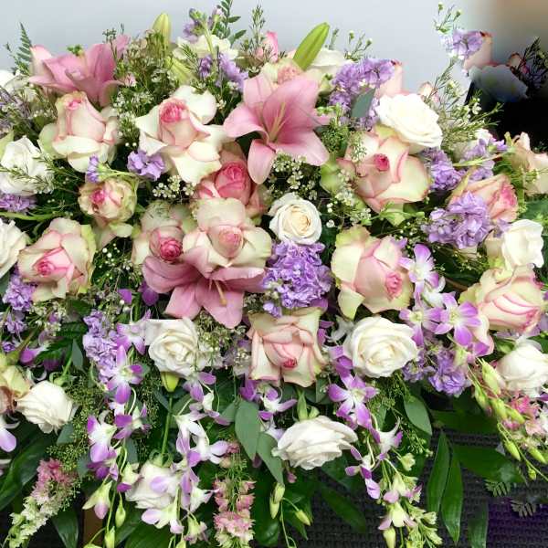 Large bouquet of pink and white roses with purple flowers