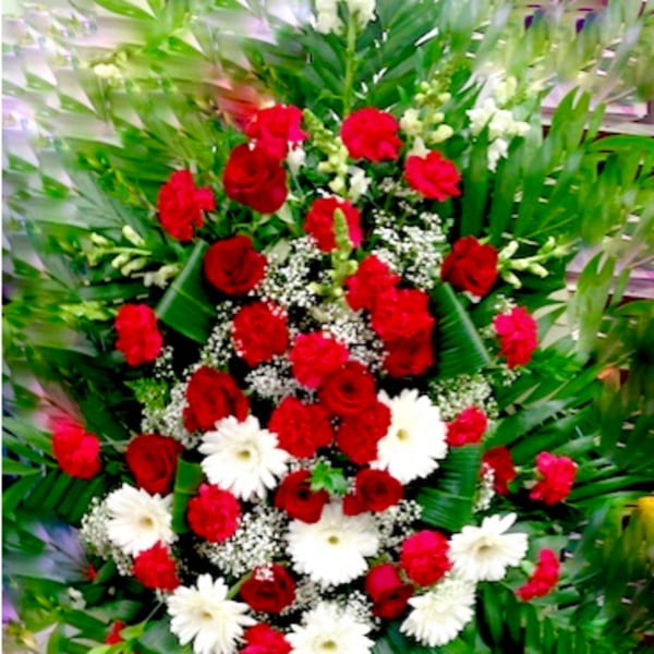 Red and white floral standing spray with greenery