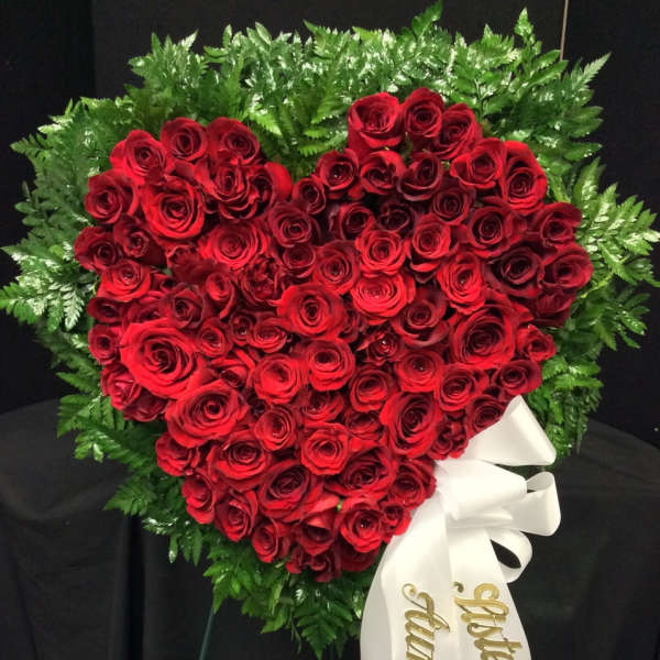 Heart-shaped red rose standing spray with white ribbon
