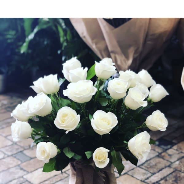 Bouquet of white roses wrapped in burlap