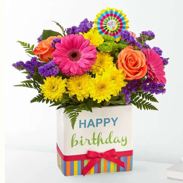 Colorful mixed bouquet in a birthday gift box with a ribbon