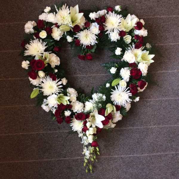 Heart-shaped floral wreath with red and white flowers