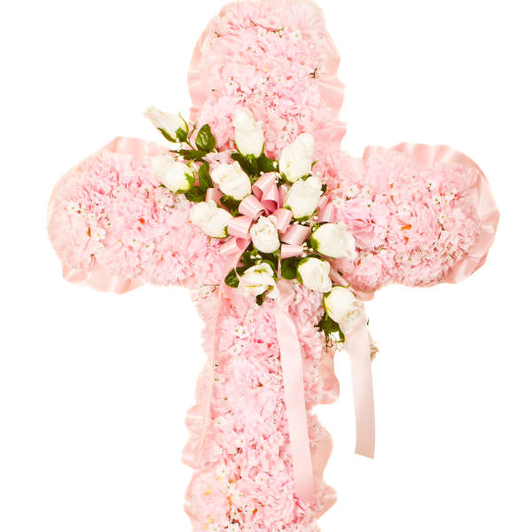 Pink carnation cross with white roses and pink ribbon accents on a white background