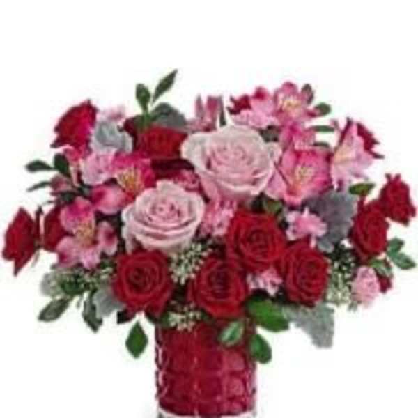 Red and pink rose bouquet in a red vase