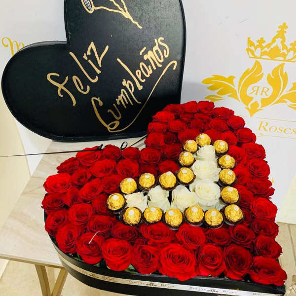 Heart-shaped box of red roses with chocolates and white roses