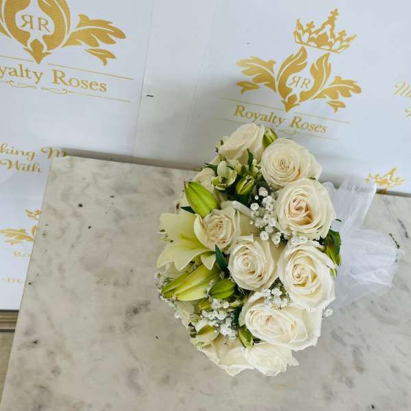 Cream rose bouquet with white lilies and small filler flowers