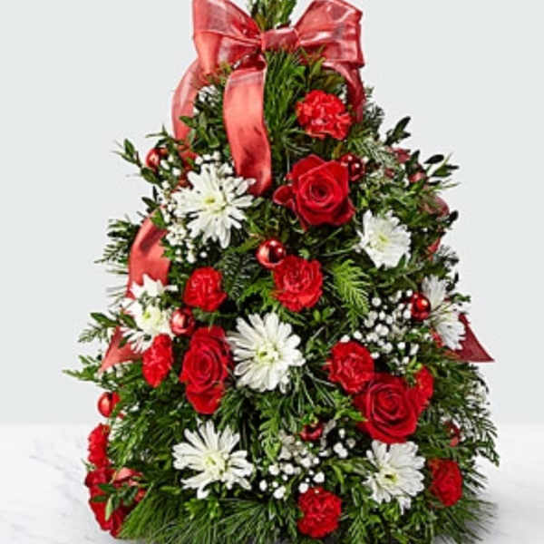 Red and white floral arrangement shaped like a Christmas tree with a ribbon bow