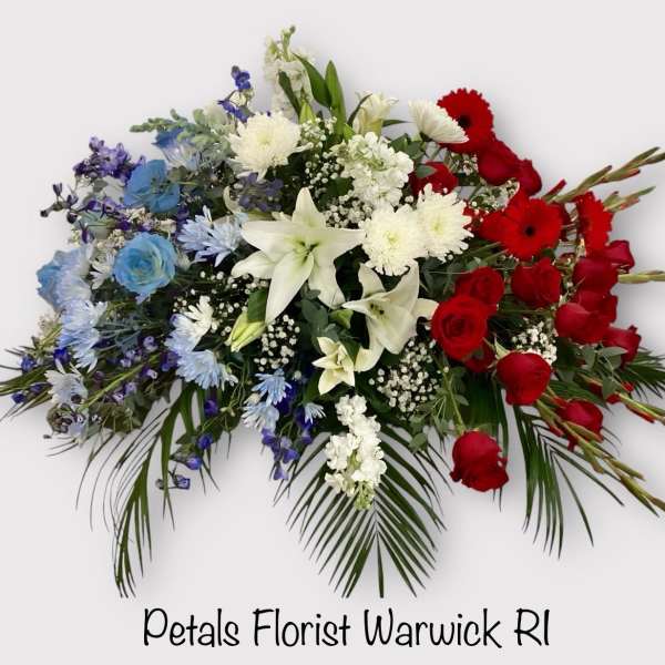 Red, white, and blue floral spray with roses and lilies