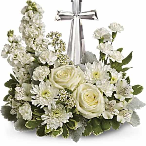 White floral arrangement with a silver cross centerpiece