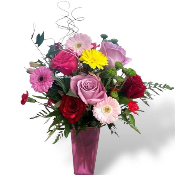 Mixed bouquet of roses and gerbera daisies in a pink vase