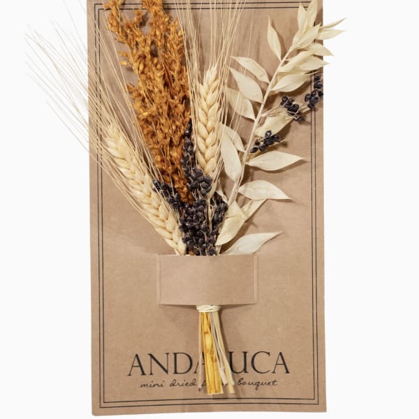 Dried bouquet of wheat and seed stems on a kraft paper card