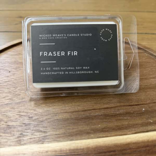 Fraser fir wax melt in a clear plastic clamshell
