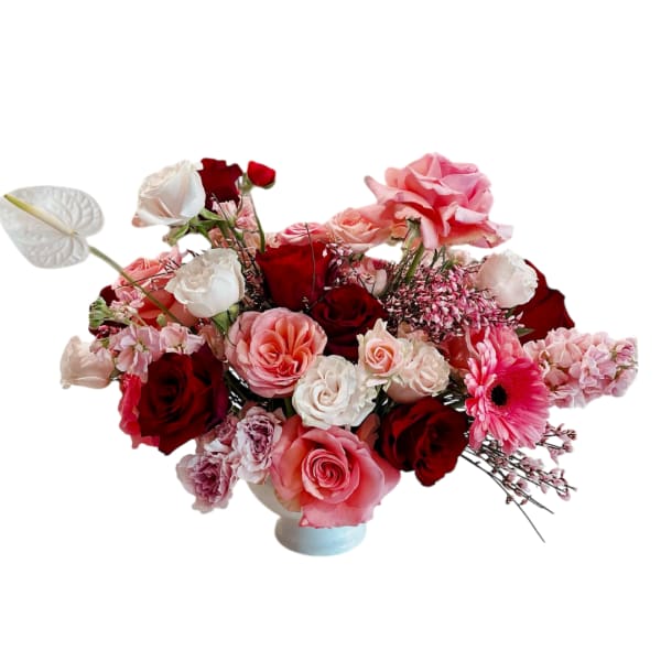 Pink and red rose arrangement in a low vase