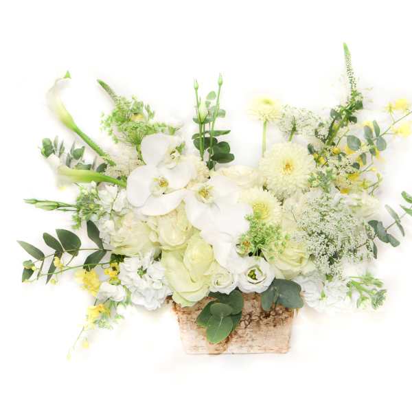 White floral arrangement in a rustic rectangular container