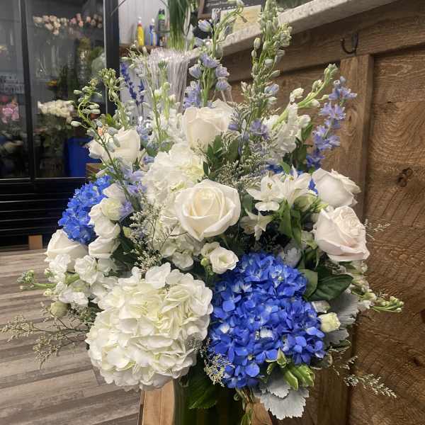 Blue and white floral arrangement in a glass vase