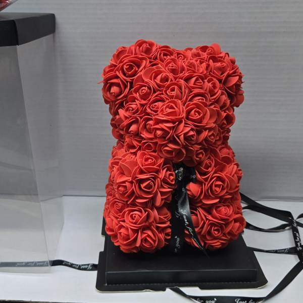 Red rose teddy bear in a clear gift box with a black lid