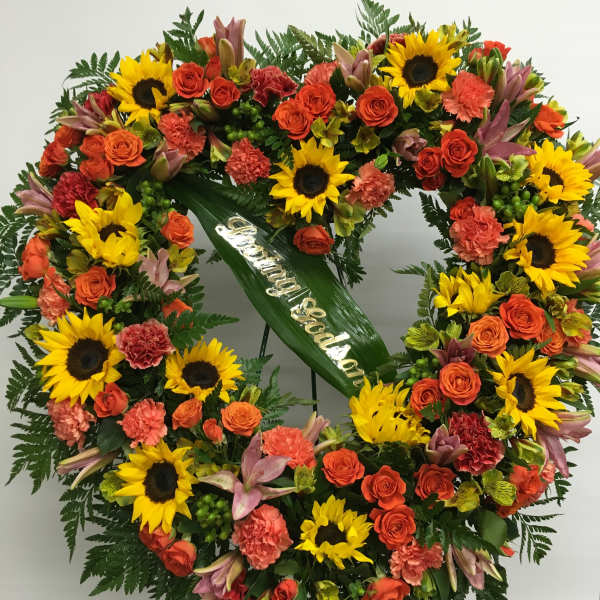 Heart-shaped floral wreath with sunflowers and orange roses