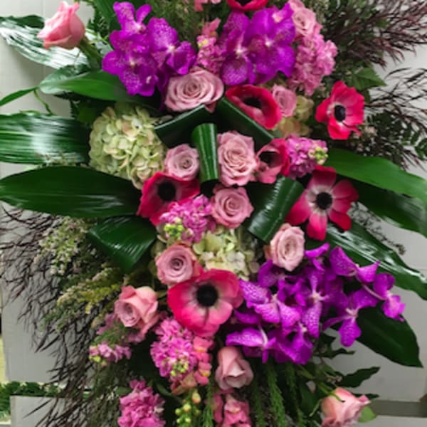 Tall standing floral spray with pink and purple blooms