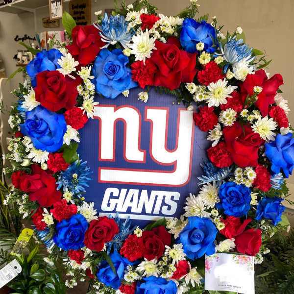 Large floral wreath around a New York Giants sign with red and blue roses