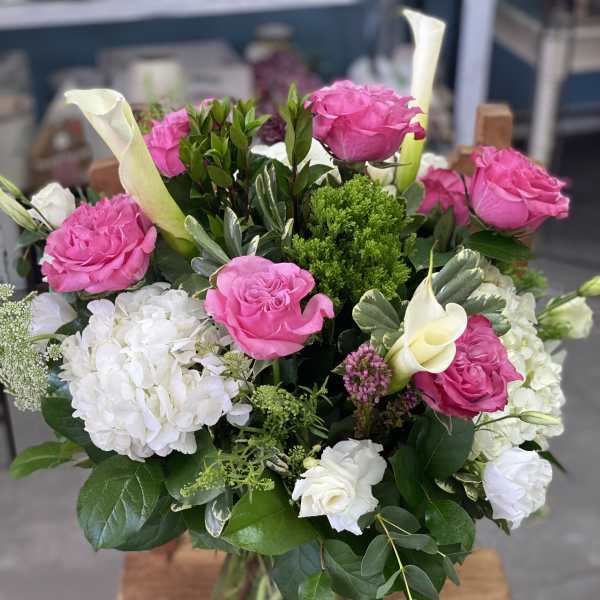 Pink roses and white hydrangeas in a glass vase
