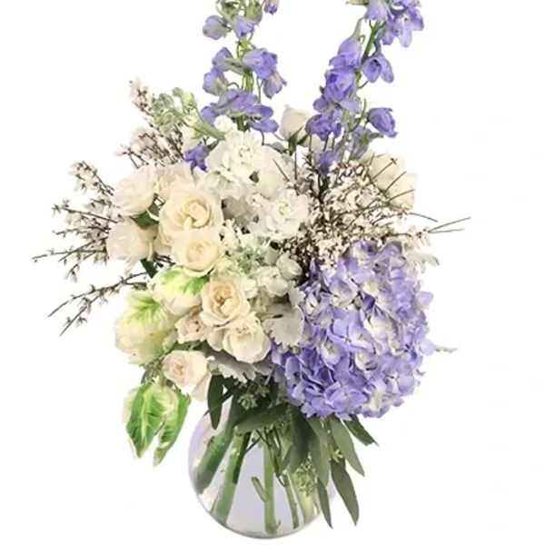 White and lavender floral arrangement in a clear vase
