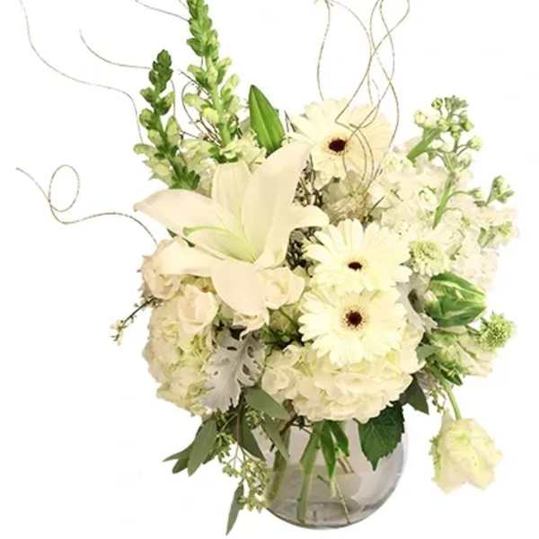 White floral arrangement in a glass vase with lilies and daisies