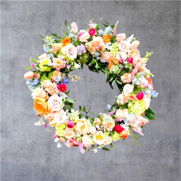 Circular floral wreath with pastel roses and mixed blooms