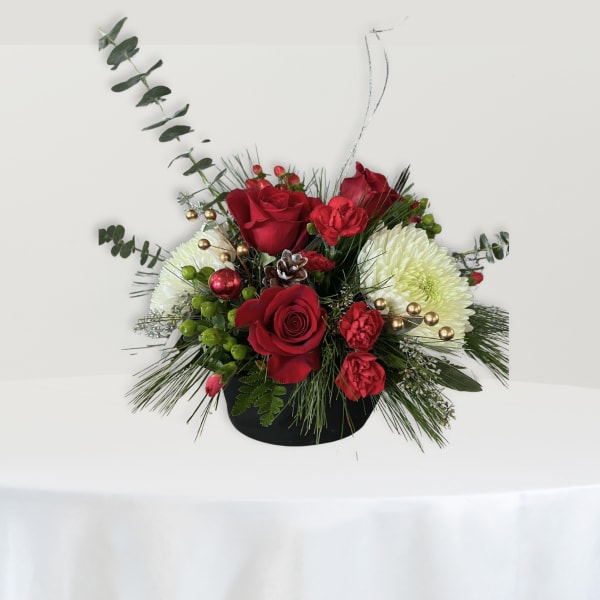 Red roses and white chrysanthemums arranged in a black vase