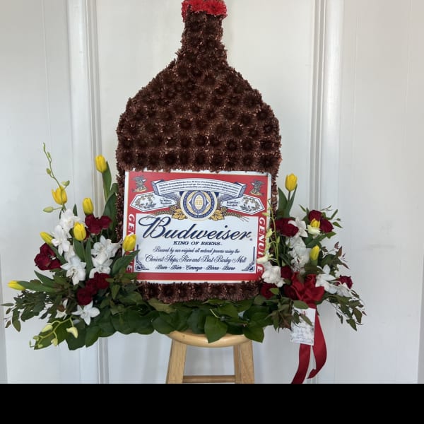 Budweiser bottle-shaped floral arrangement with red, white, and yellow flowers