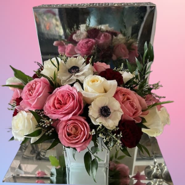 Pink and white rose bouquet with white anemones in a mirrored box