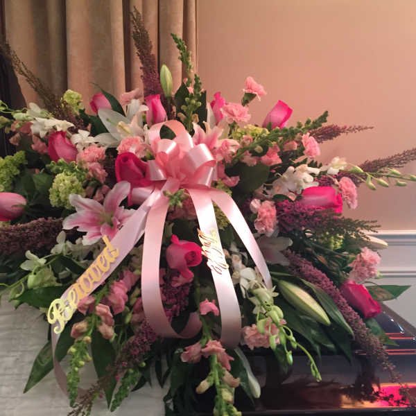 Large pink and white floral spray with a ribbon bow