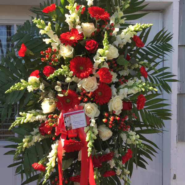 Large red and white sympathy spray with roses and gerbera daisies