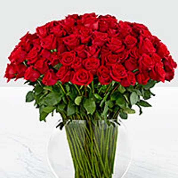 Large bouquet of red roses in a clear glass vase