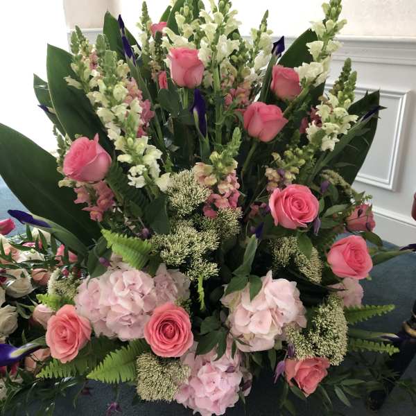 Pink roses and hydrangeas with white snapdragons in a large arrangement