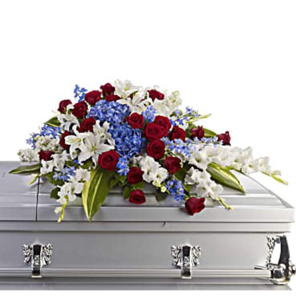 Red roses and white lilies arranged on a silver casket