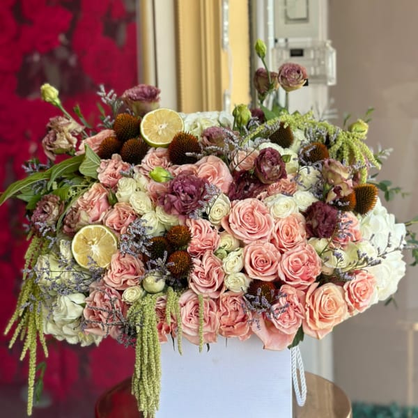 Large bouquet of pink and white roses in a white box