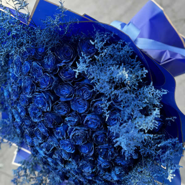 Bouquet of blue roses with airy blue filler