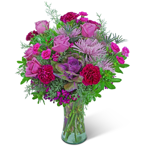 Pink and purple bouquet of roses, carnations, and chrysanthemums in a glass vase