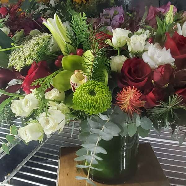 Mixed bouquet of red and white roses with green chrysanthemums in a vase