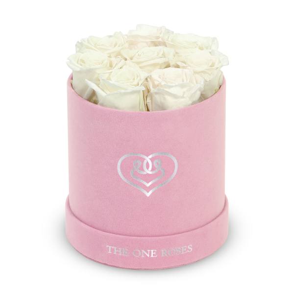 White roses in a pink round box with a heart logo
