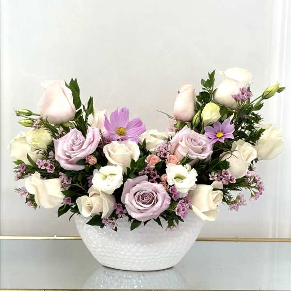 Pastel roses and cosmos arranged in a white bowl vase