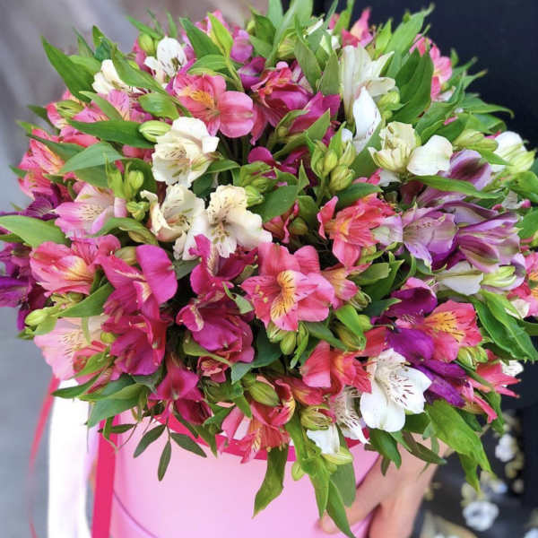 Pink and white alstroemeria bouquet in a round pink box