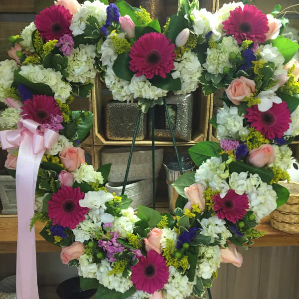 Heart-shaped floral wreath with pink gerberas and roses